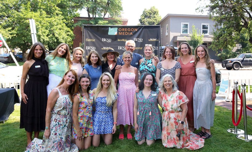 Oregon Media team in front of Step and Repeat Backdrop