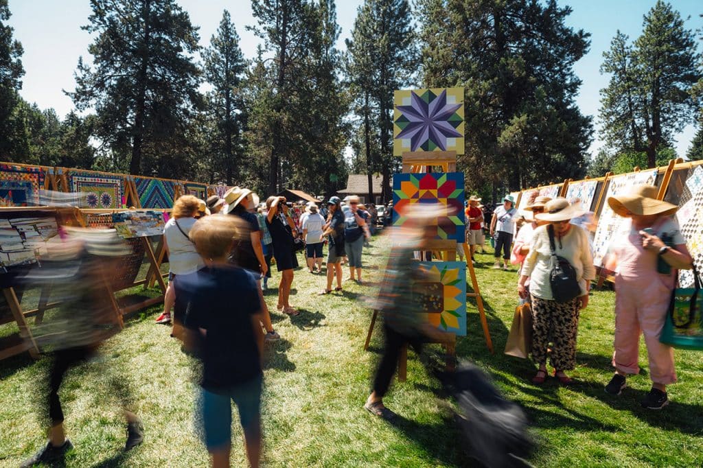 Attendees viewing quilts at the Sisters Quilt Show