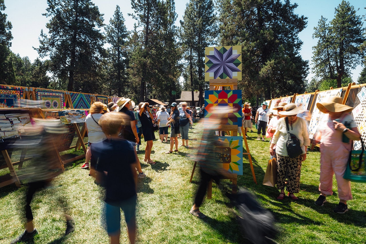 Attendees viewing quilts at the Sisters Quilt Show