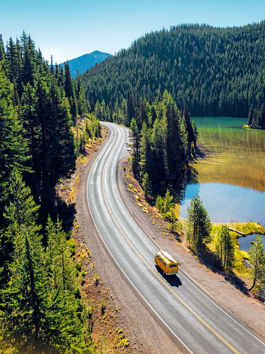 Yellow VW Bus driving down Cascade Lakes Highway