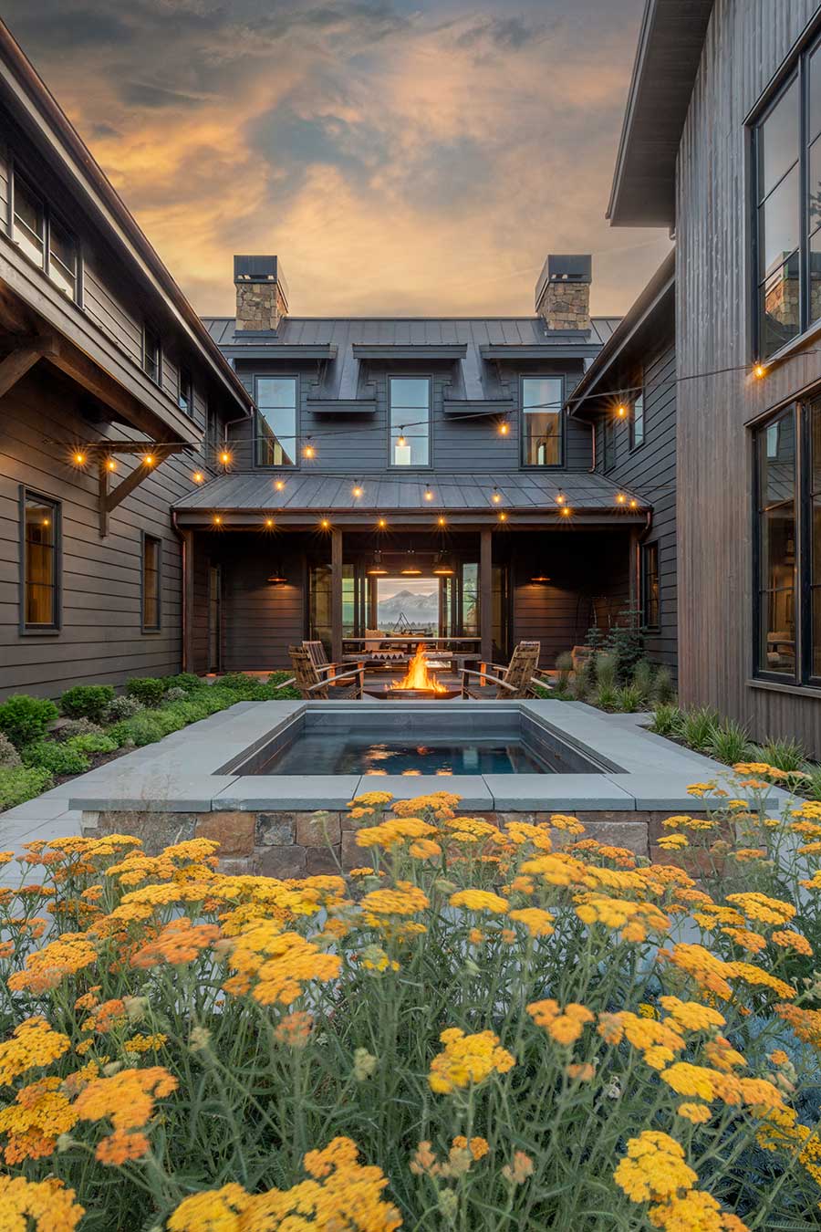 Luxury ranch house exterior with pond in Tumalo Oregon by Copperline Homes.