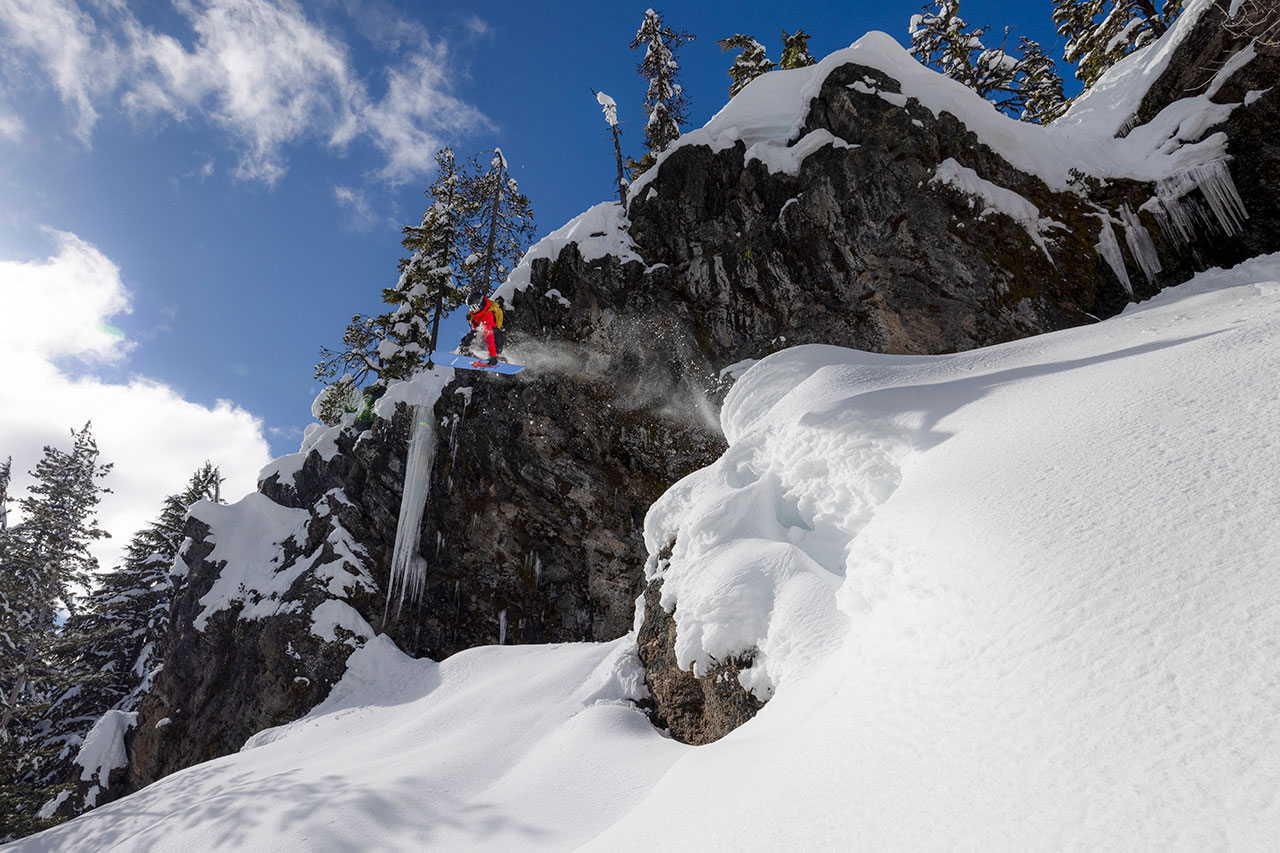 skier launching off jump in backcountry