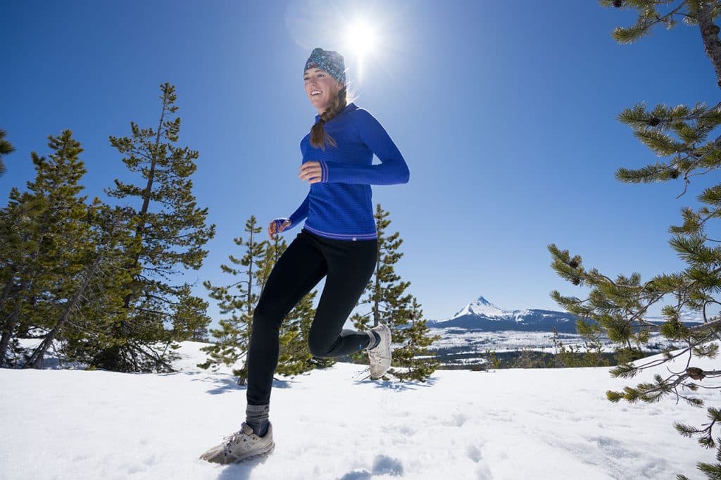Woman running in snow