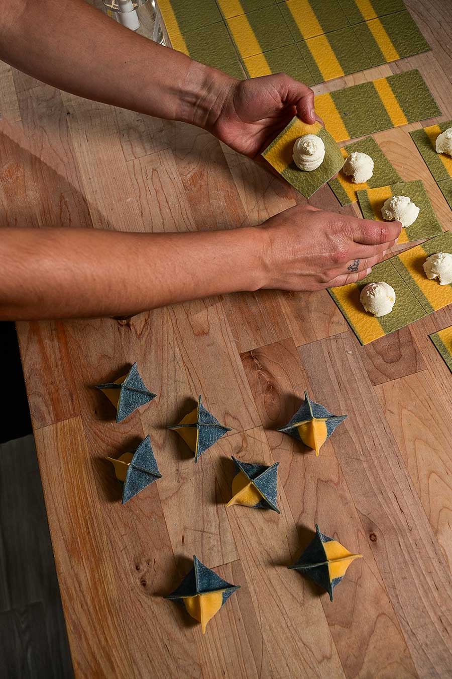 ravioli being rolled into triangle shapes