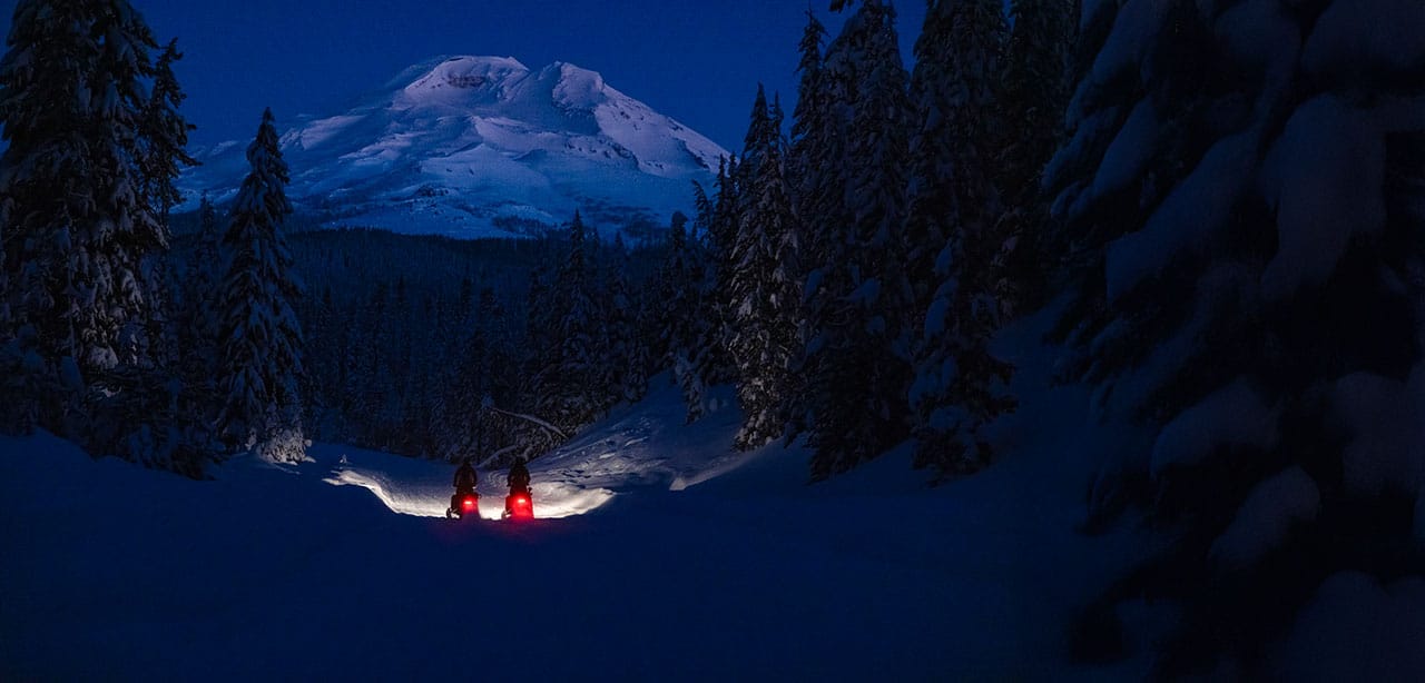 early sunrise snowmobile commute backcountry ski