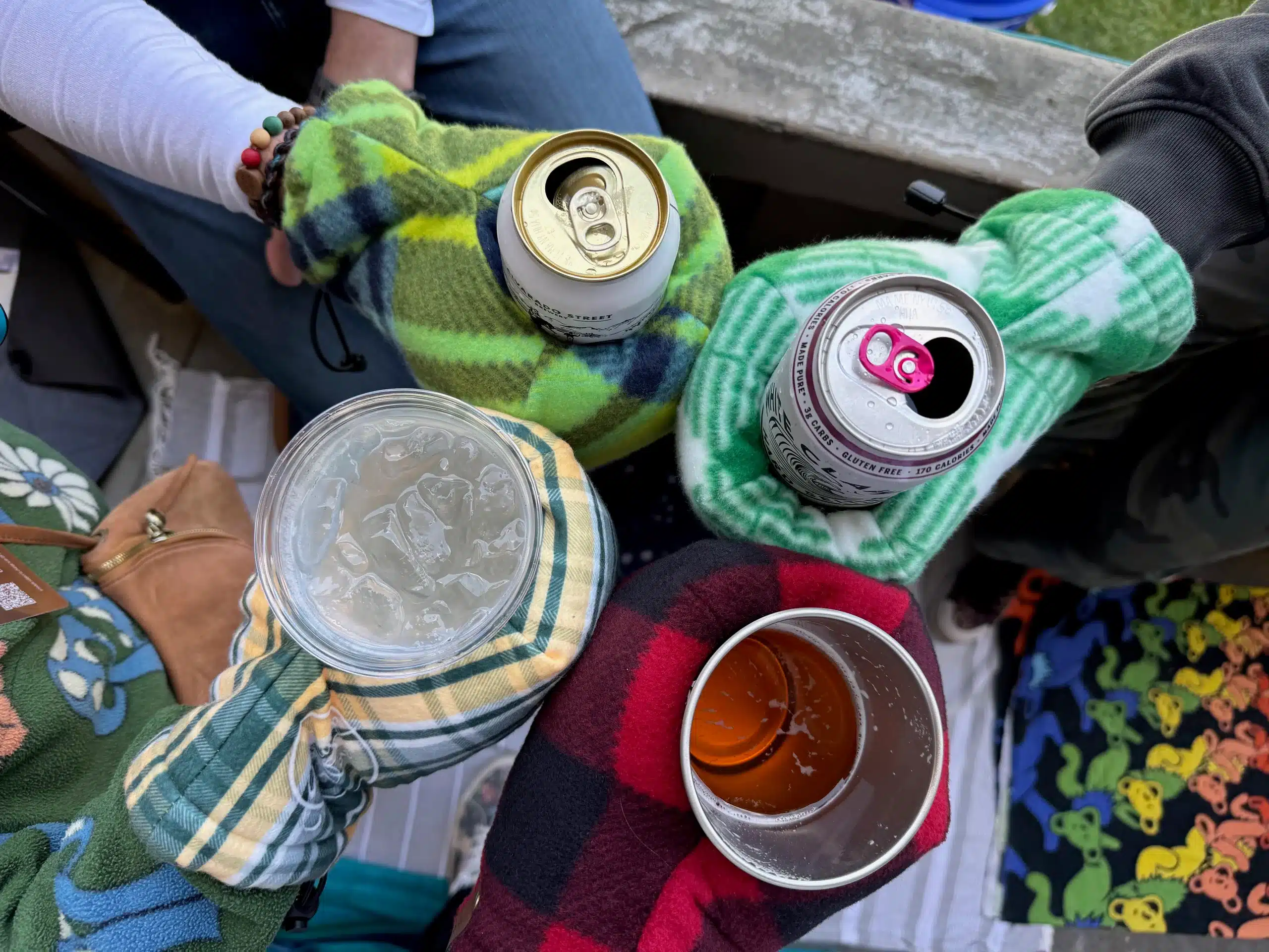 hands holding beverages with gloves cheers