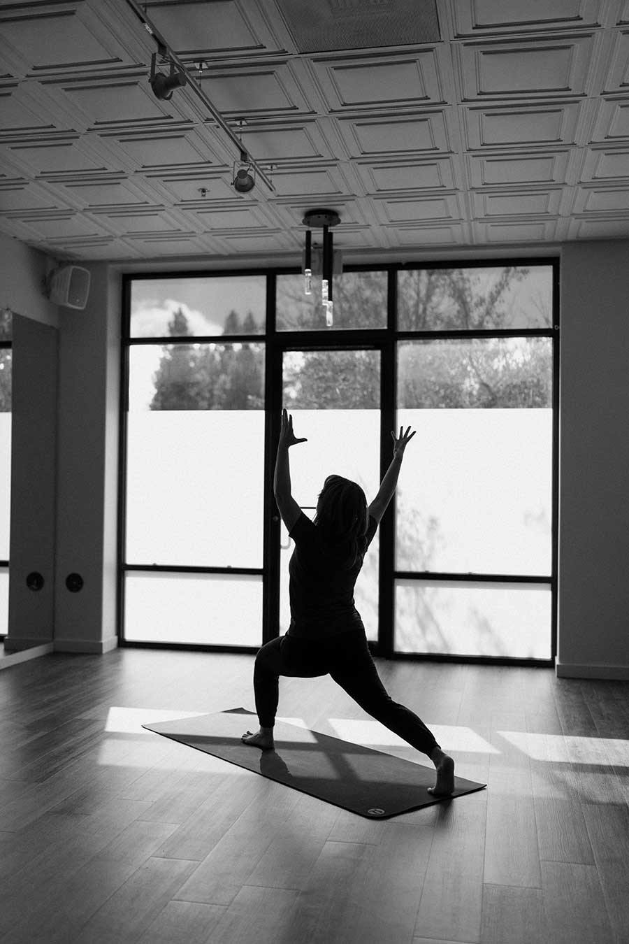 Yoga mat pose in front of exterior window in yoga studio