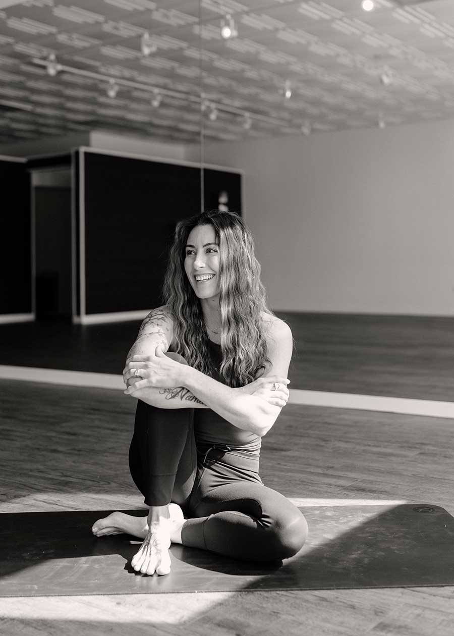 sitting on yoga mat at yoga studio