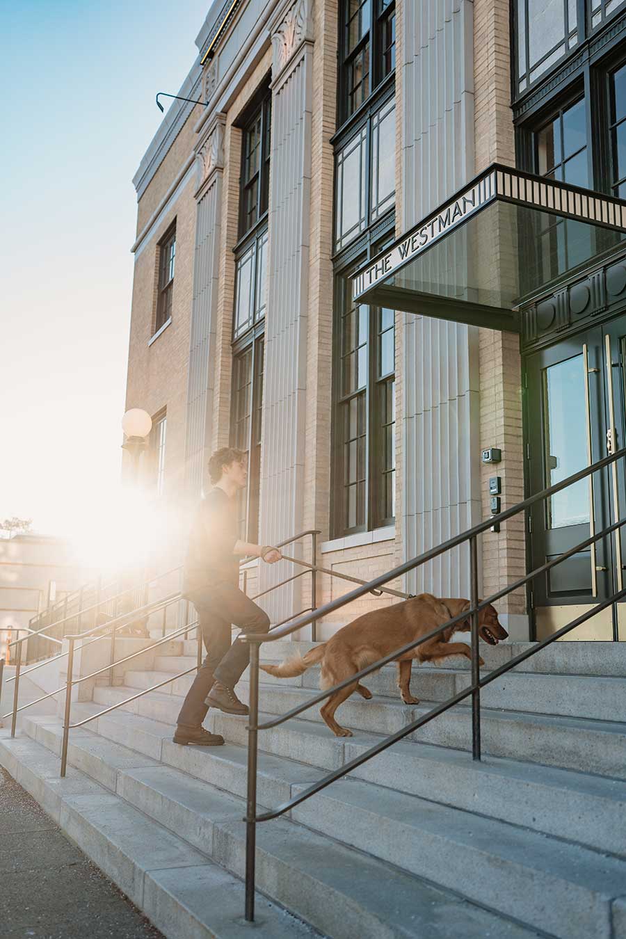 Man and dog walk into the westman