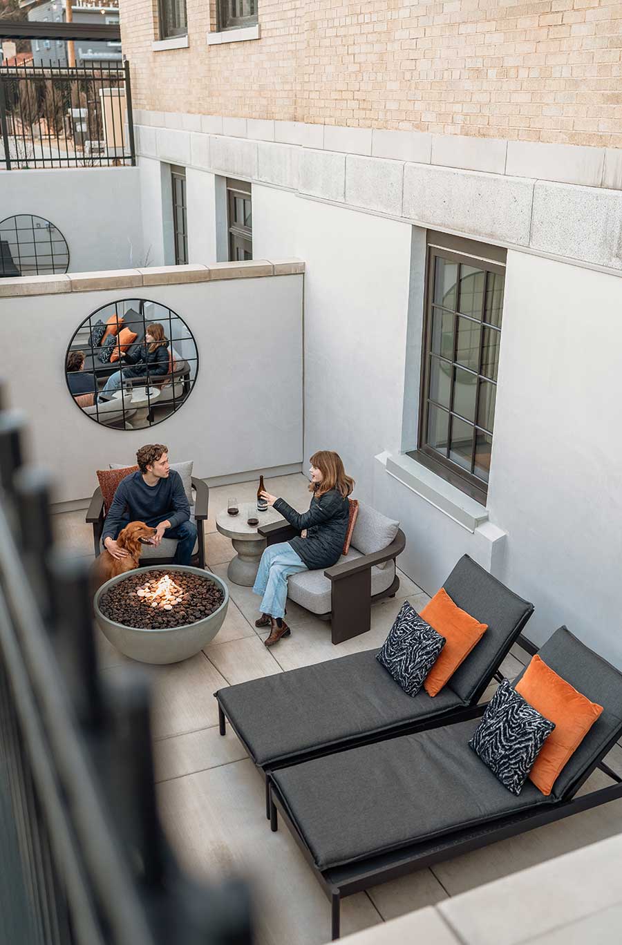 People enjoy private fireplace on their enclosed patio