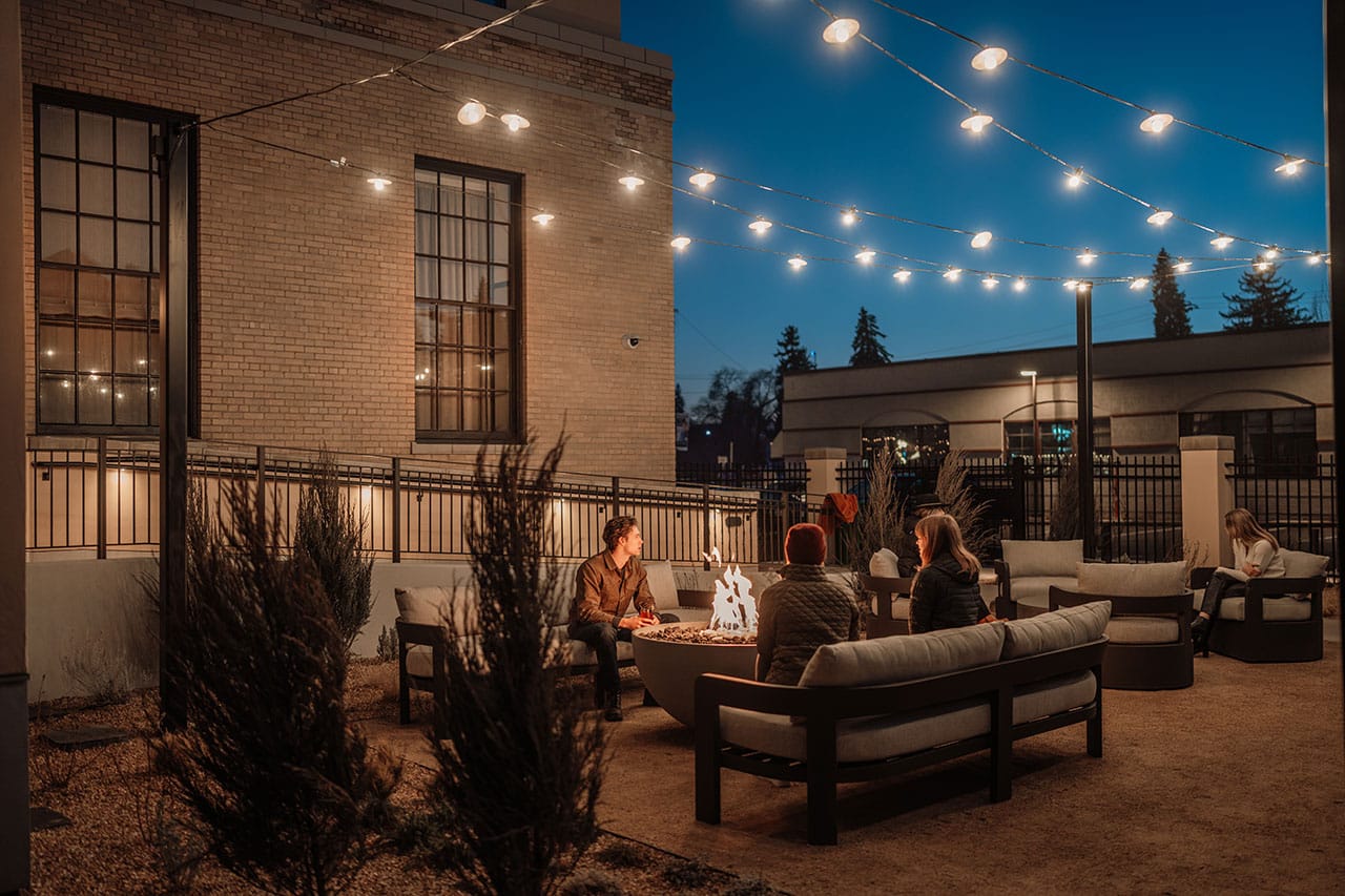 People on patio at night at the westman