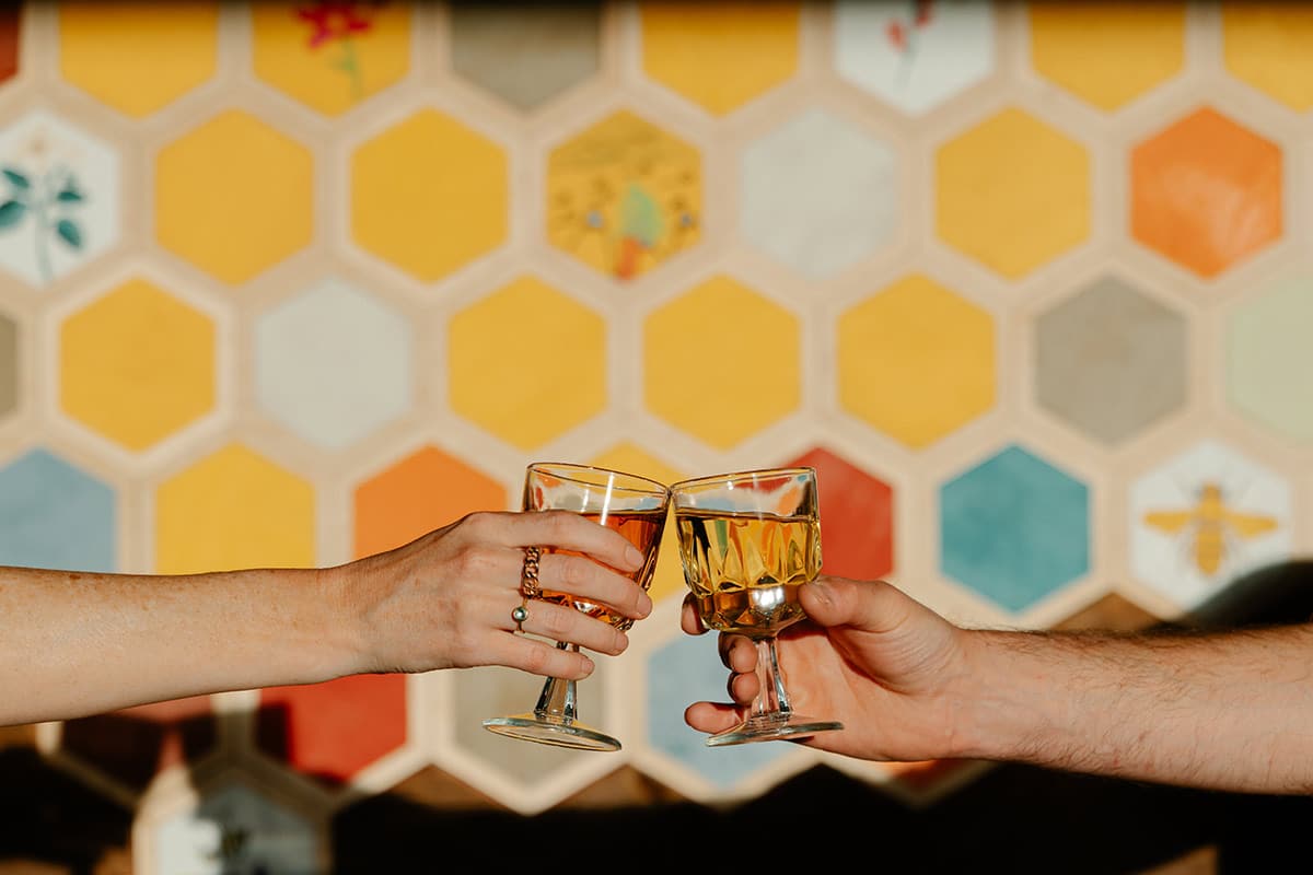 Cheers with mead in front of the Lazy Z Ranch Wines decor