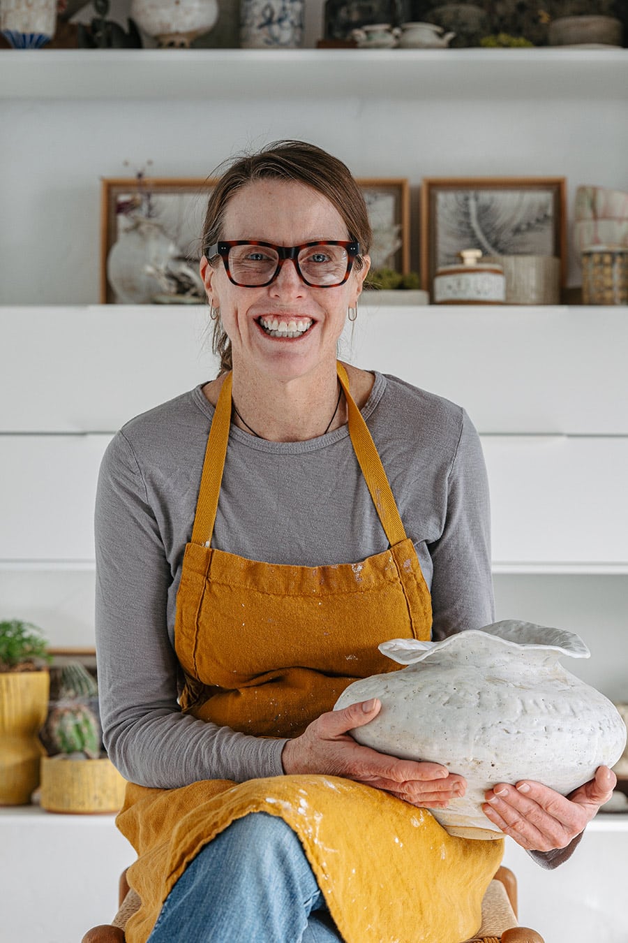 Heidi holding a final piece of art HWH Ceramics