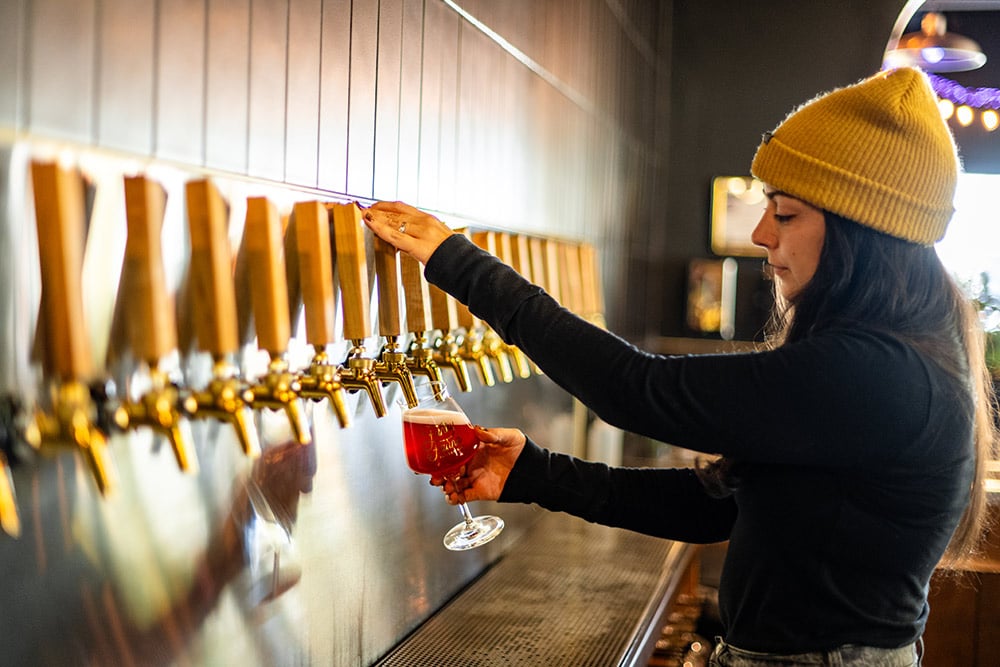 Danielle Burns pouring beers at Funky Fauna Artisan Ales