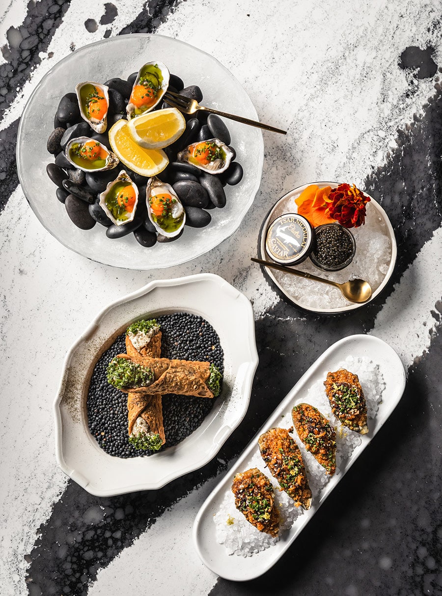 Caviar and oysters plated beautifully on black and white at Lady Bird Cultural Society Restaurant