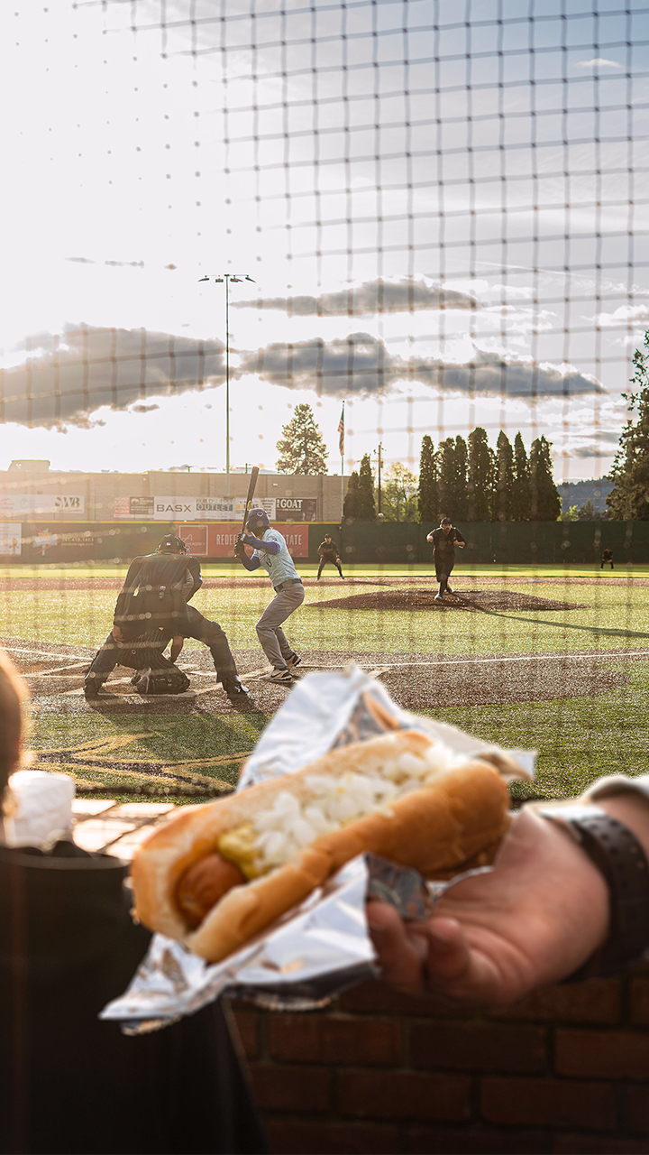 Enjoying a hot dog at a Bend Elks game at Vince Genna Stadium