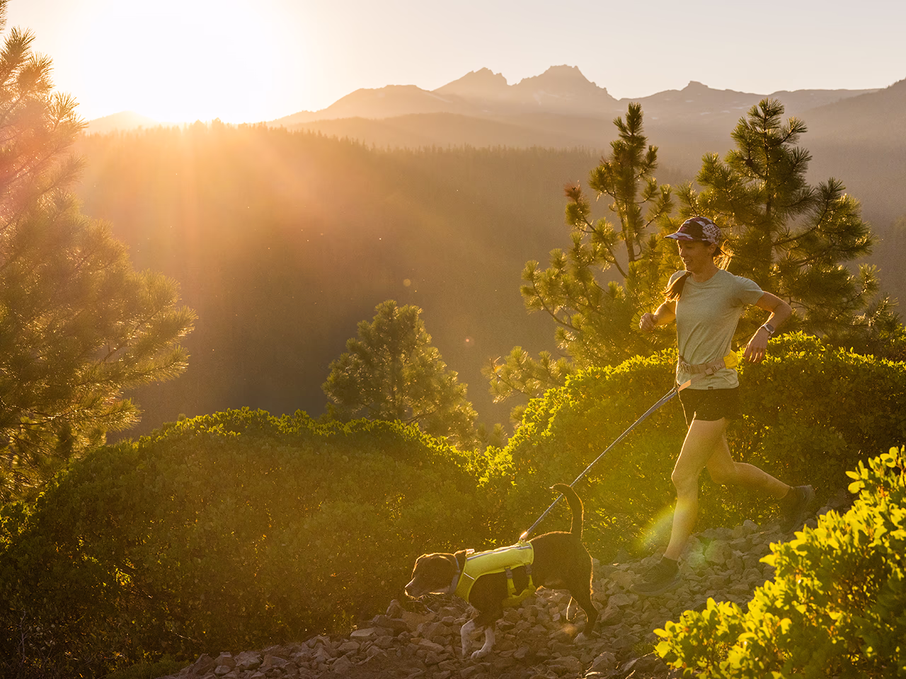 A woman and her dog run on a trail in Central Oregon