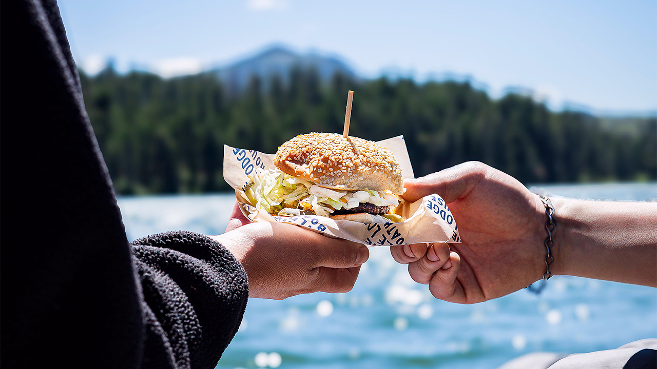 A couple eating a sandwich at the Boathouse at Suttle Lodge
