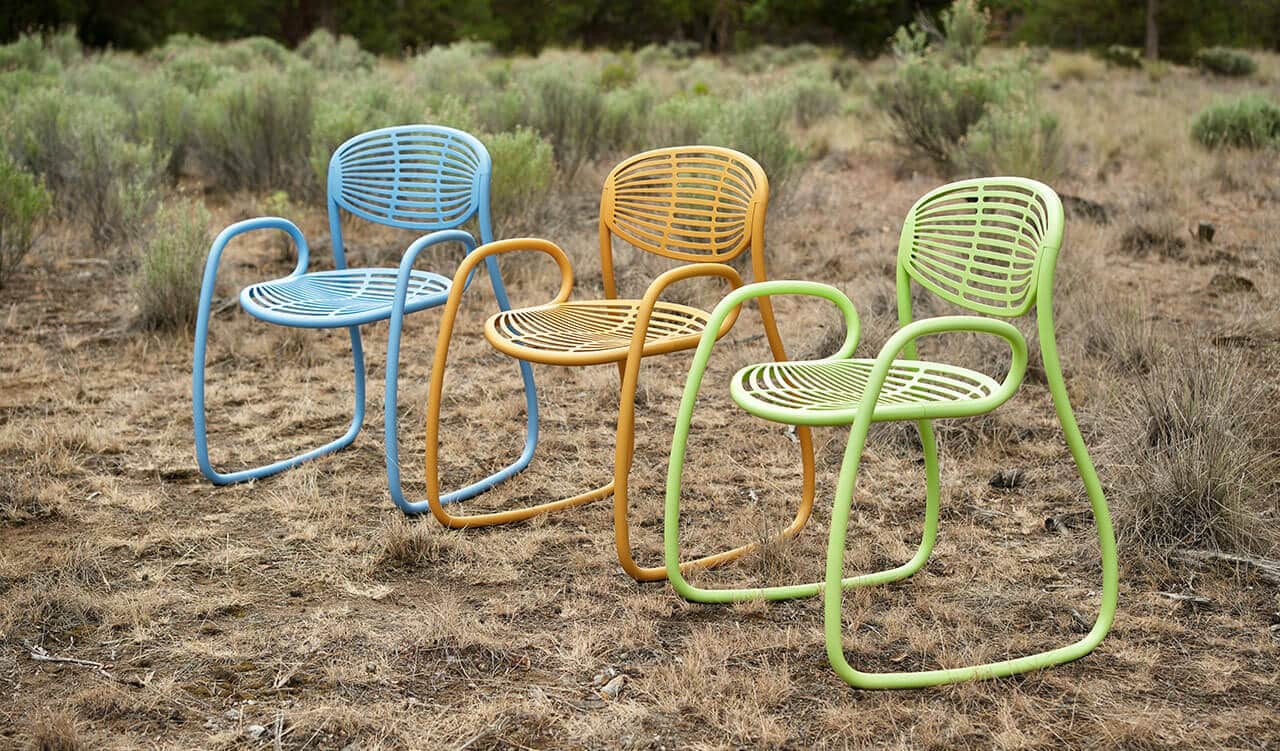 set of 3 different colored fr33form chairs sitting outside