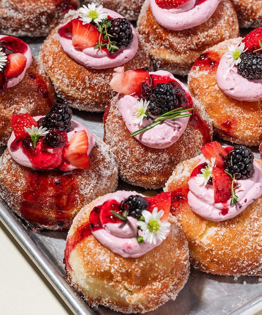 a pan of beautiful donuts by oh my goodness bakery