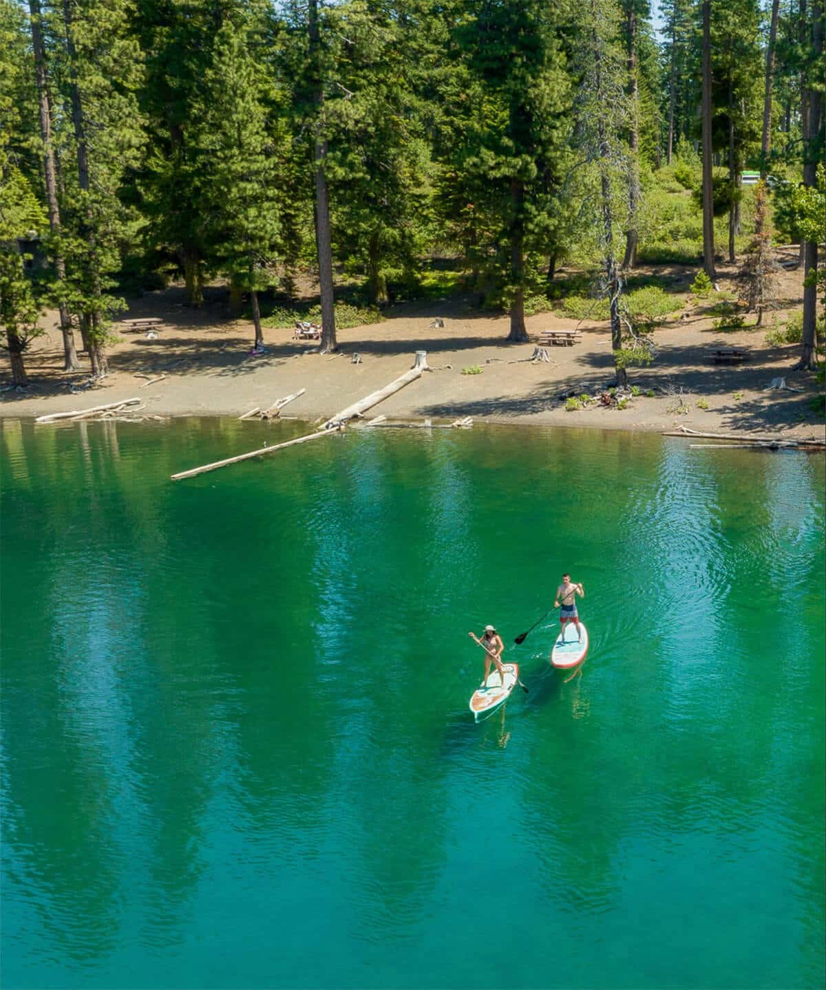 Couple paddleboarding on Scout Lake in Oregon