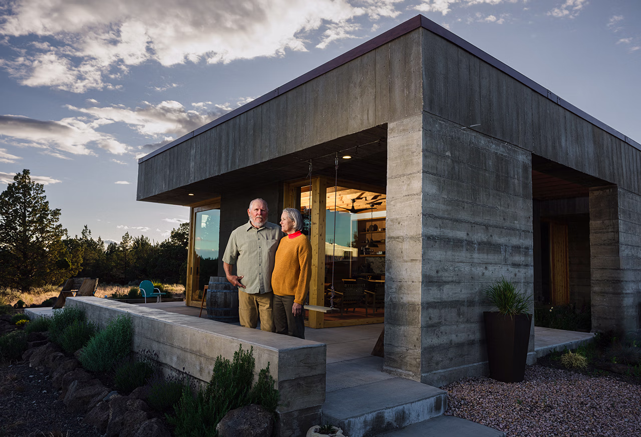 Jan and Peter Hackett outside their concrete home