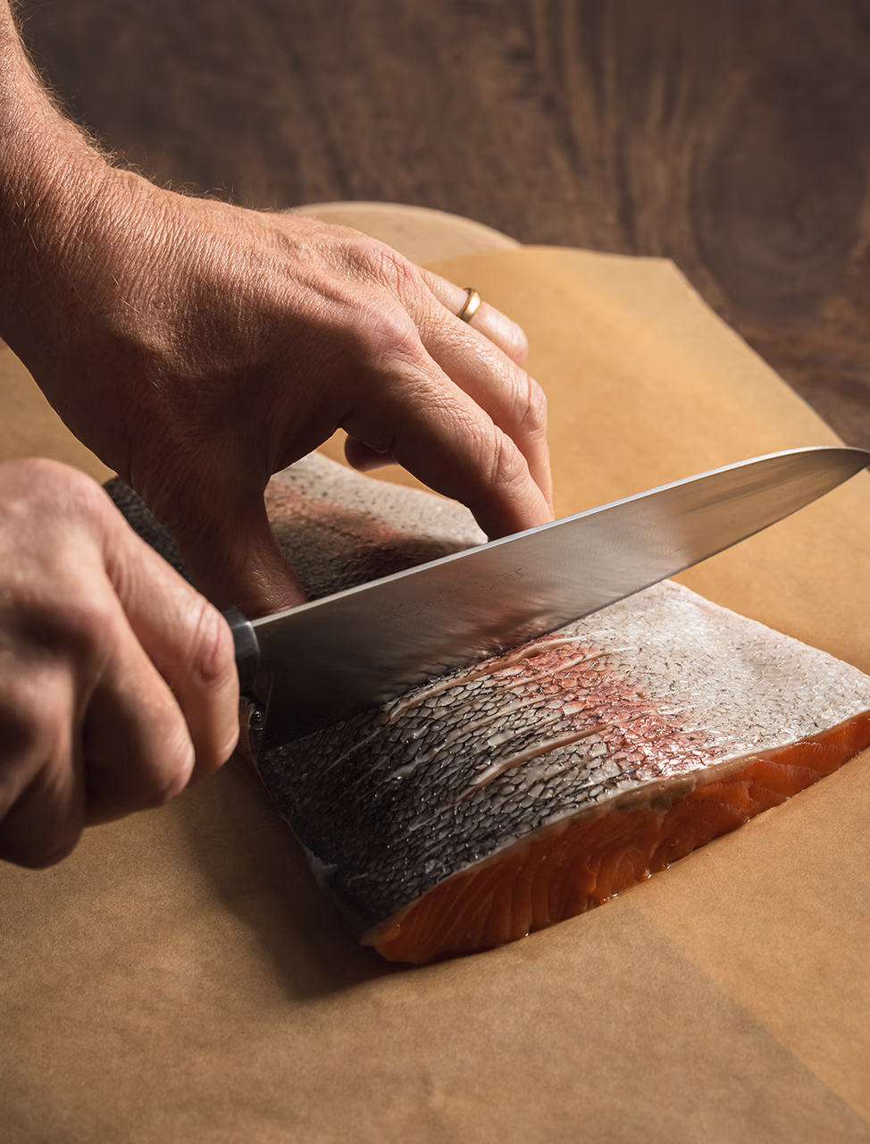 Chef cutting steelhead filets