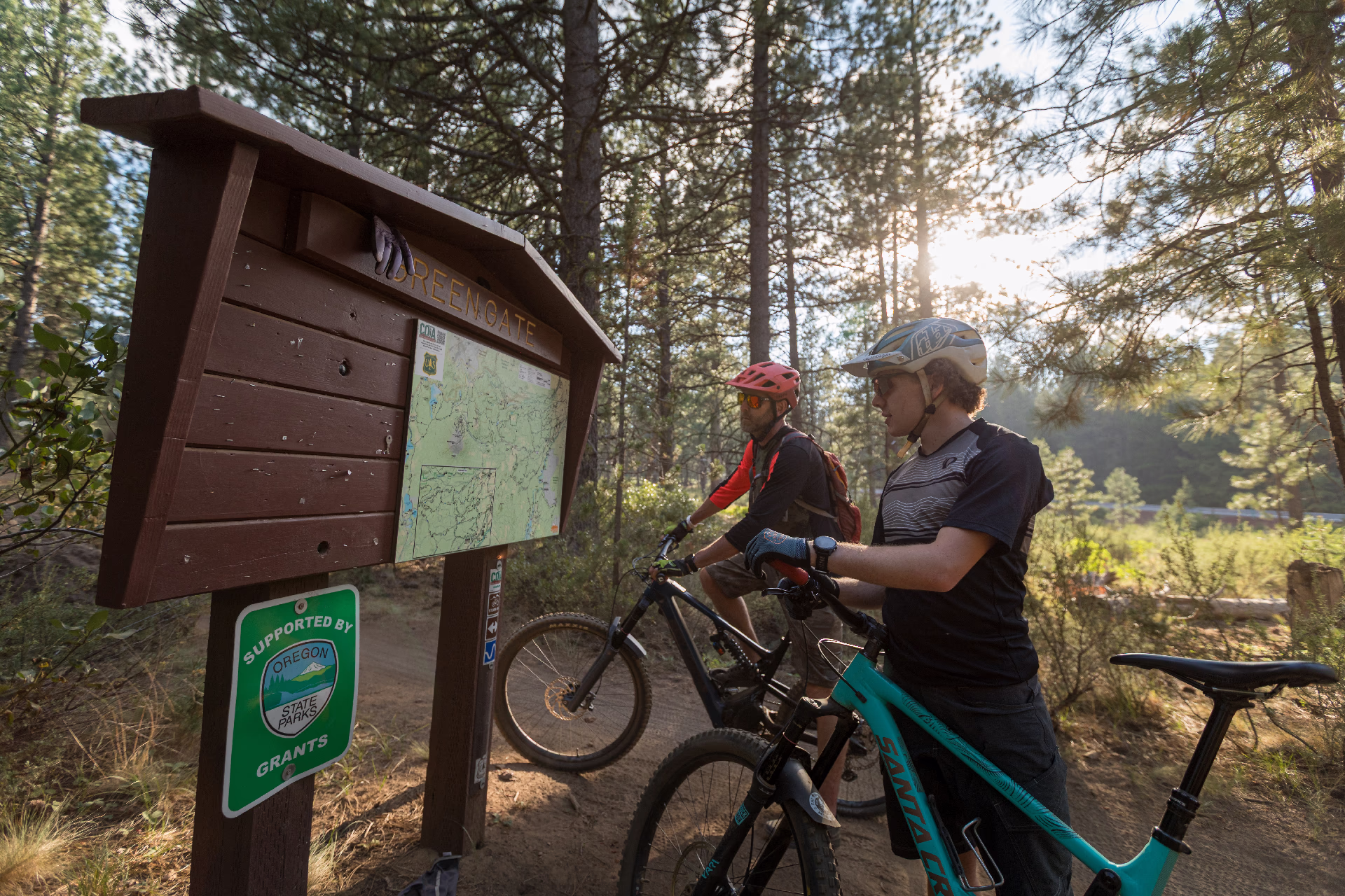 Two bikers look at a Mountain Bike Trail in Central Oregon