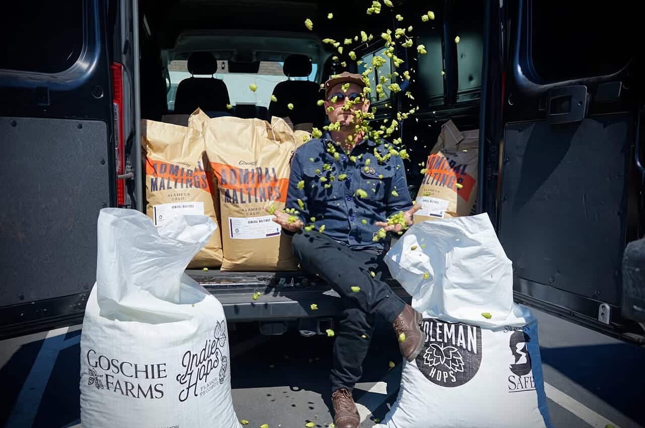 Funky Fauna brewer throwing fresh hops in the air