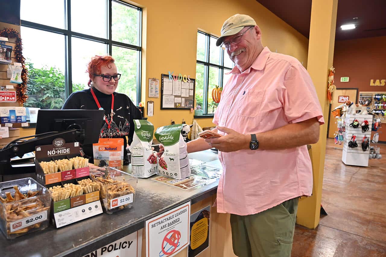 Man at register at Bend Pet Express